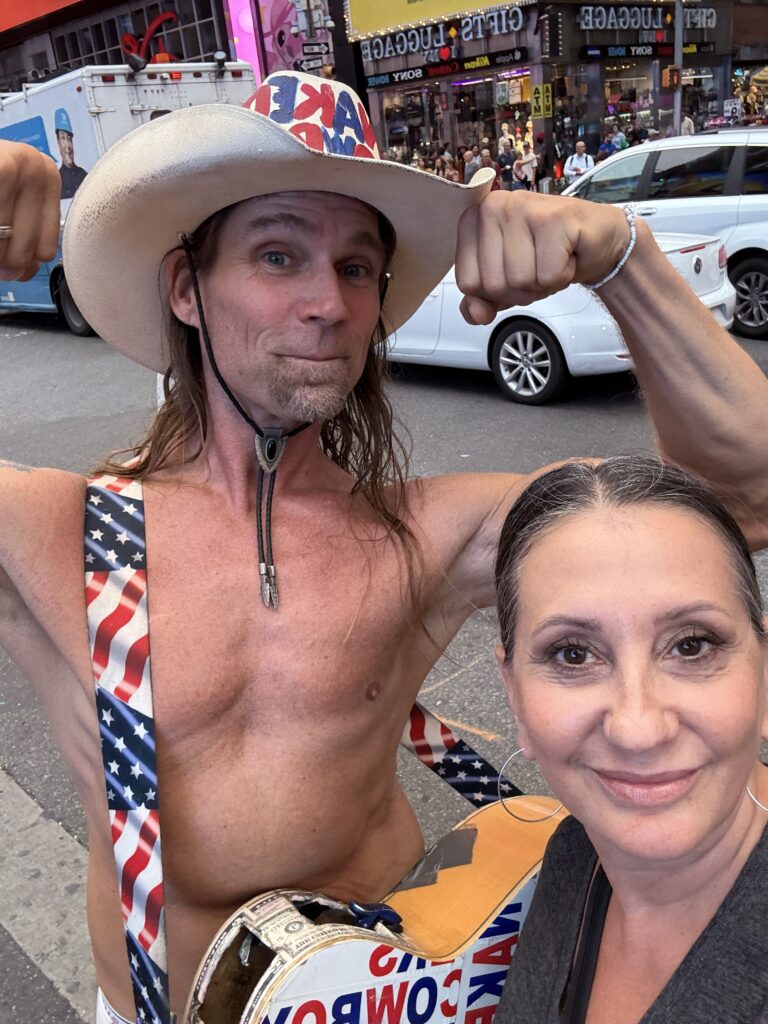 Selfie of Lisa with the Naked Cowboy street performer in Times Square, New York City