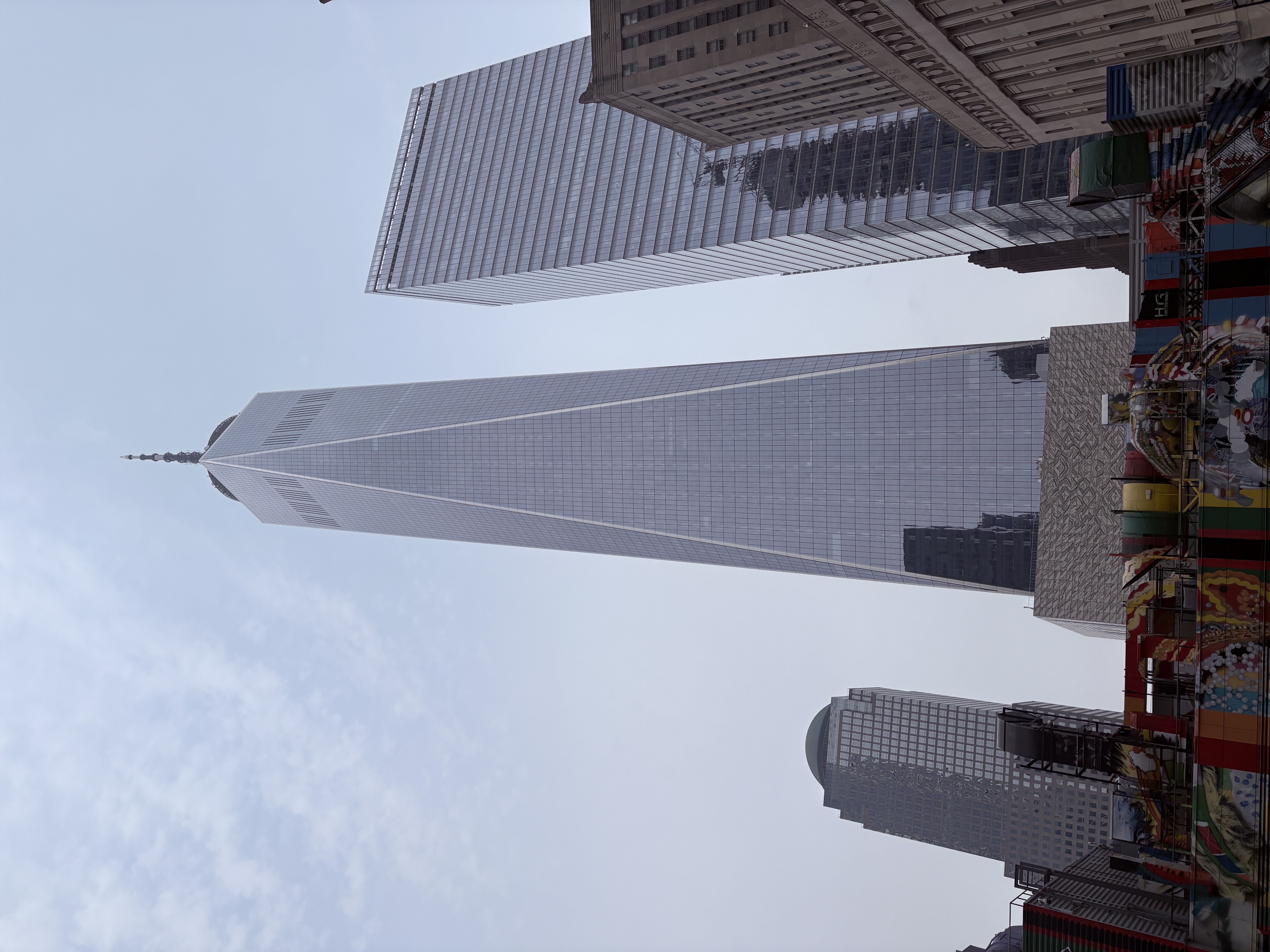 One World Trade Center skyscraper rising above surrounding buildings in New York City.