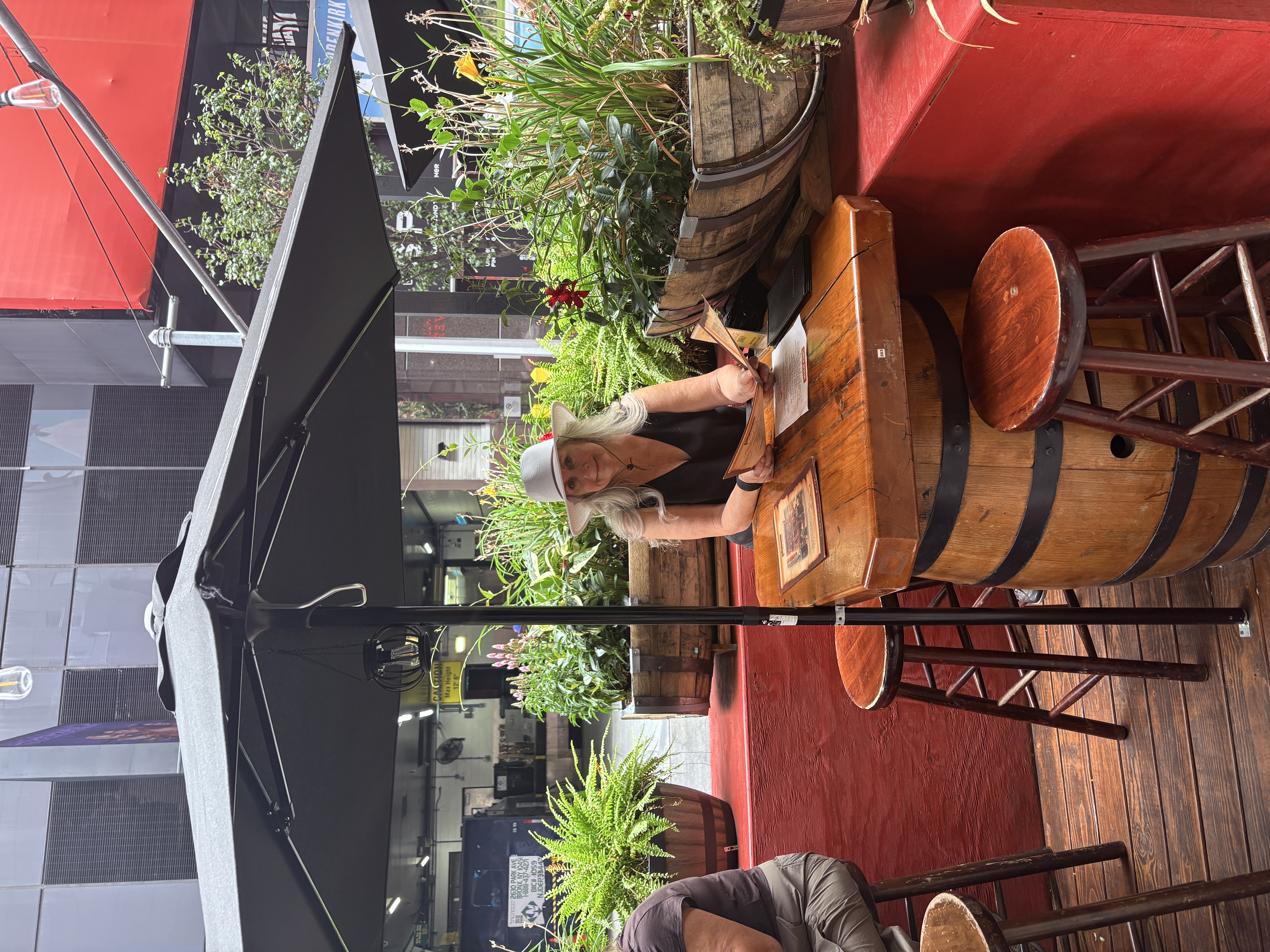 Cora sitting at an outdoor table at Playwright Celtic Pub in New York.