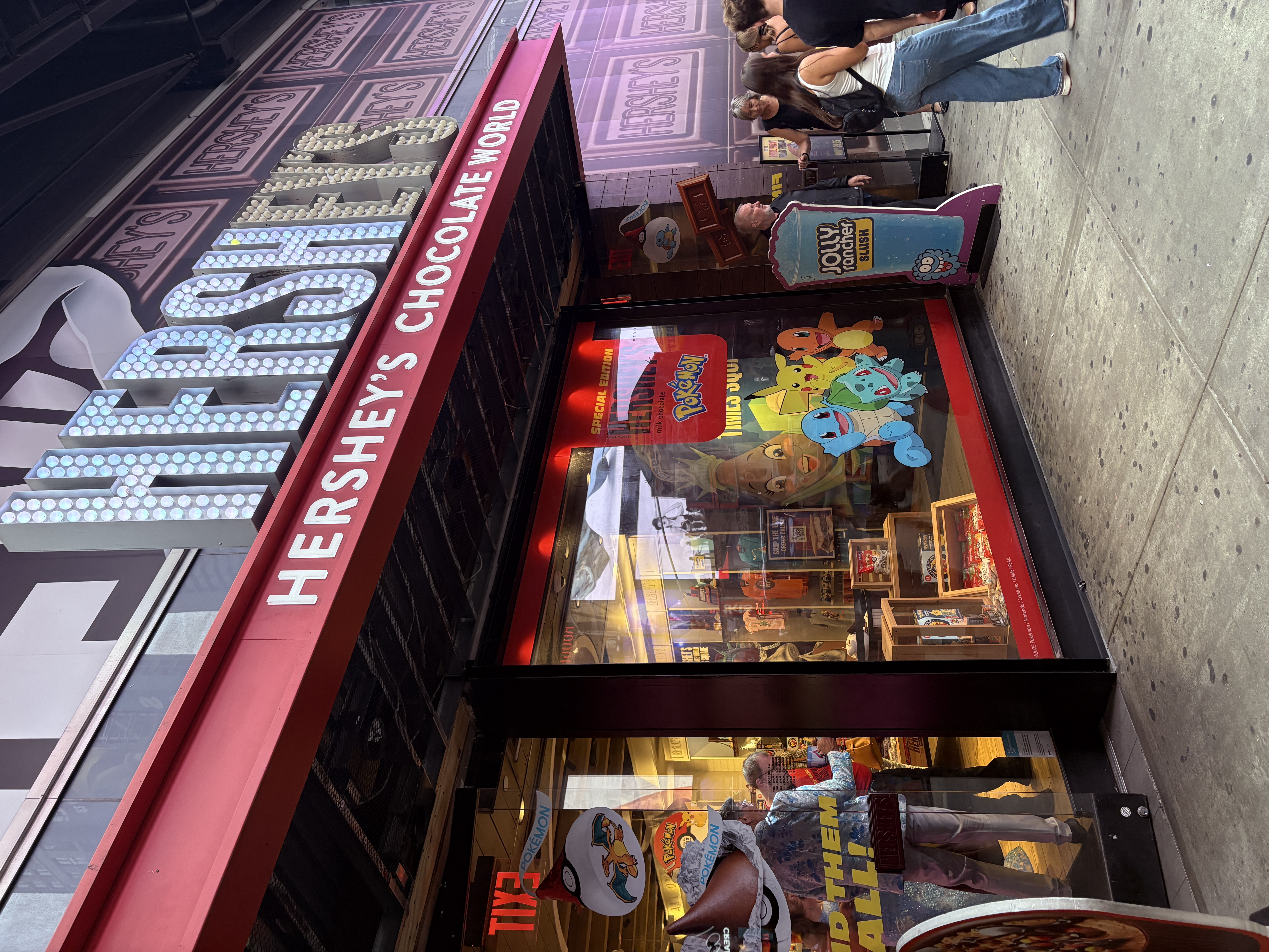 Exterior of Hershey’s Chocolate World in Times Square, featuring Pokémon displays.