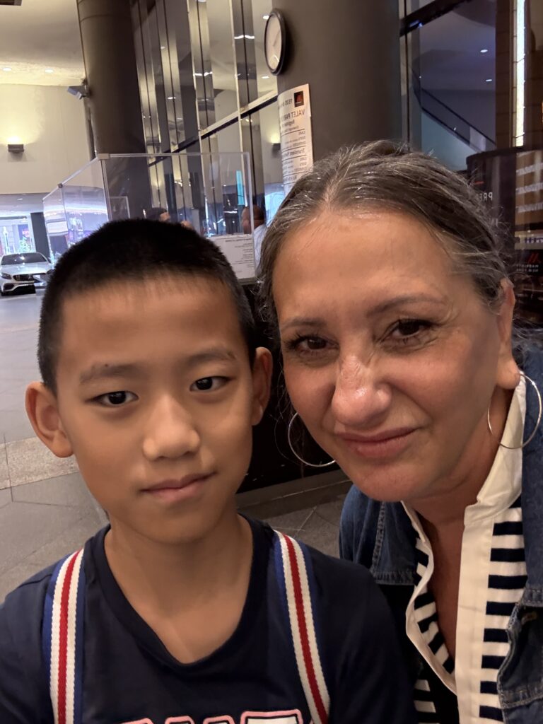 Lisa and her student William smiling closely in a casual selfie, showing their playful bond.