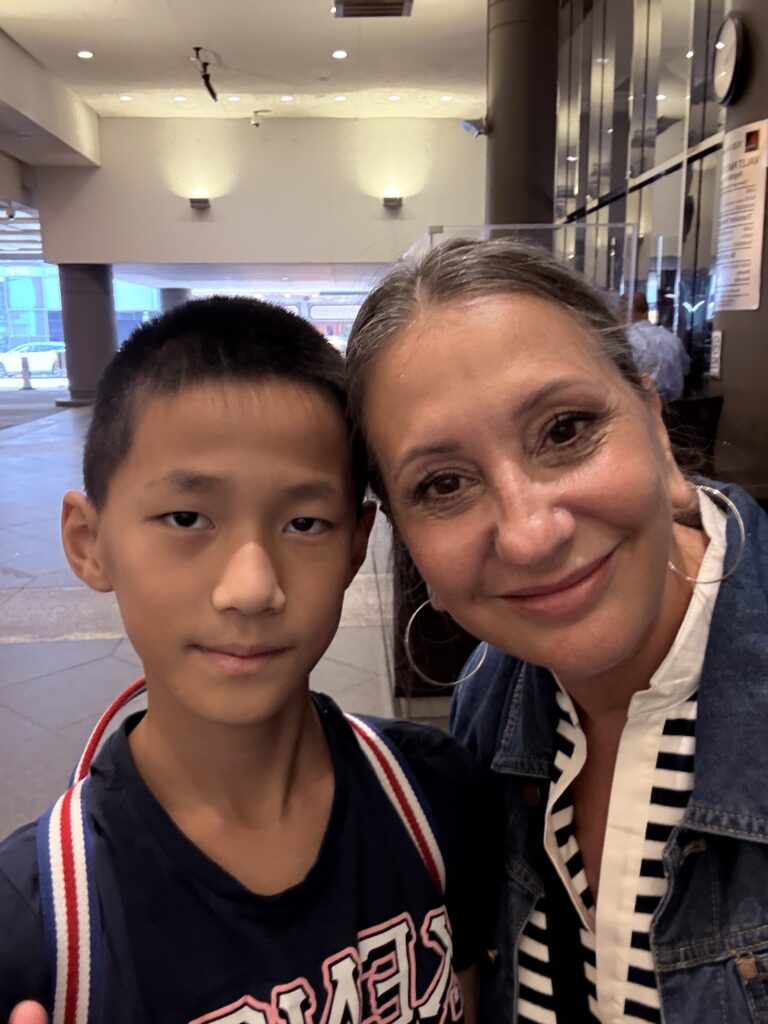 isa and her student Victor smiling together in a warm but more serious selfie.