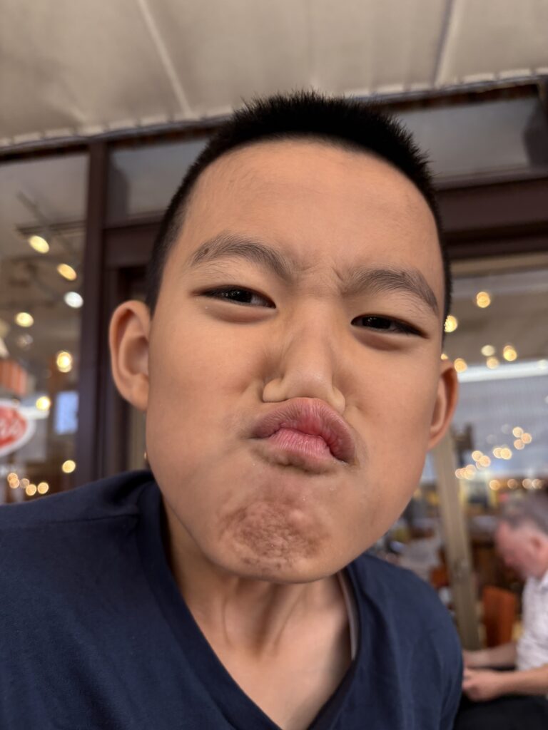 William making a silly squishy face while clowning around at Junior’s restaurant in New York.